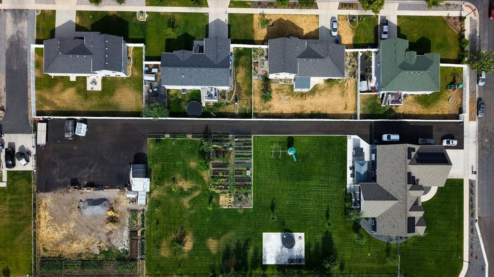 Aerial view of a finished J&C Asphalt driveway at a home in Logan, Utah