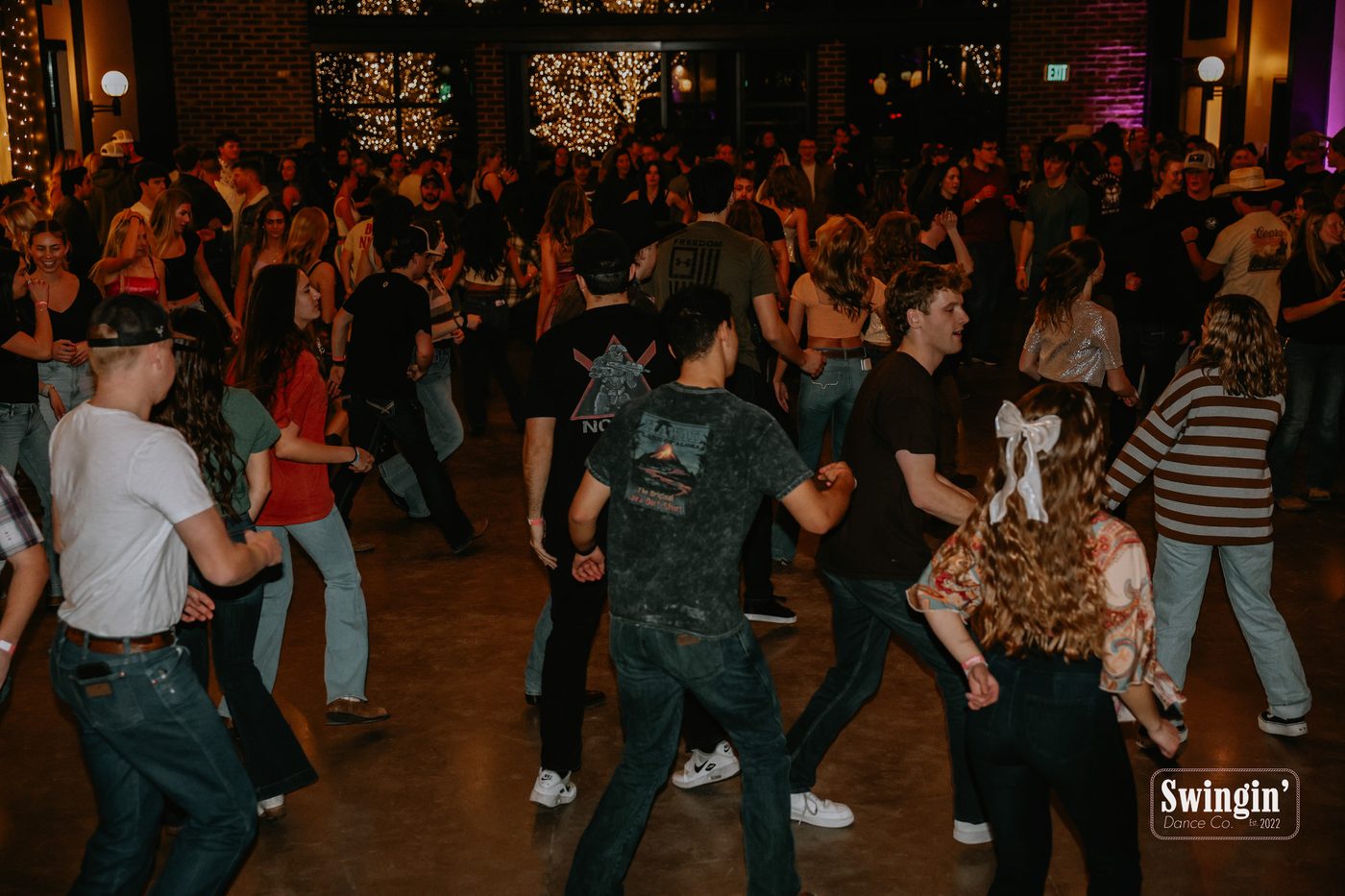 A packed dance floor at a Swingin Dance Co event, branded photo