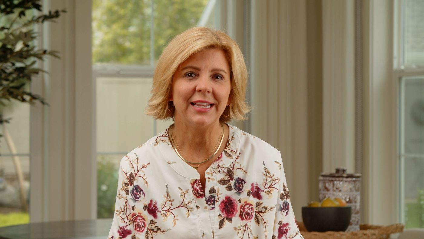 A woman speaking on camera for an Uptown Drapes video