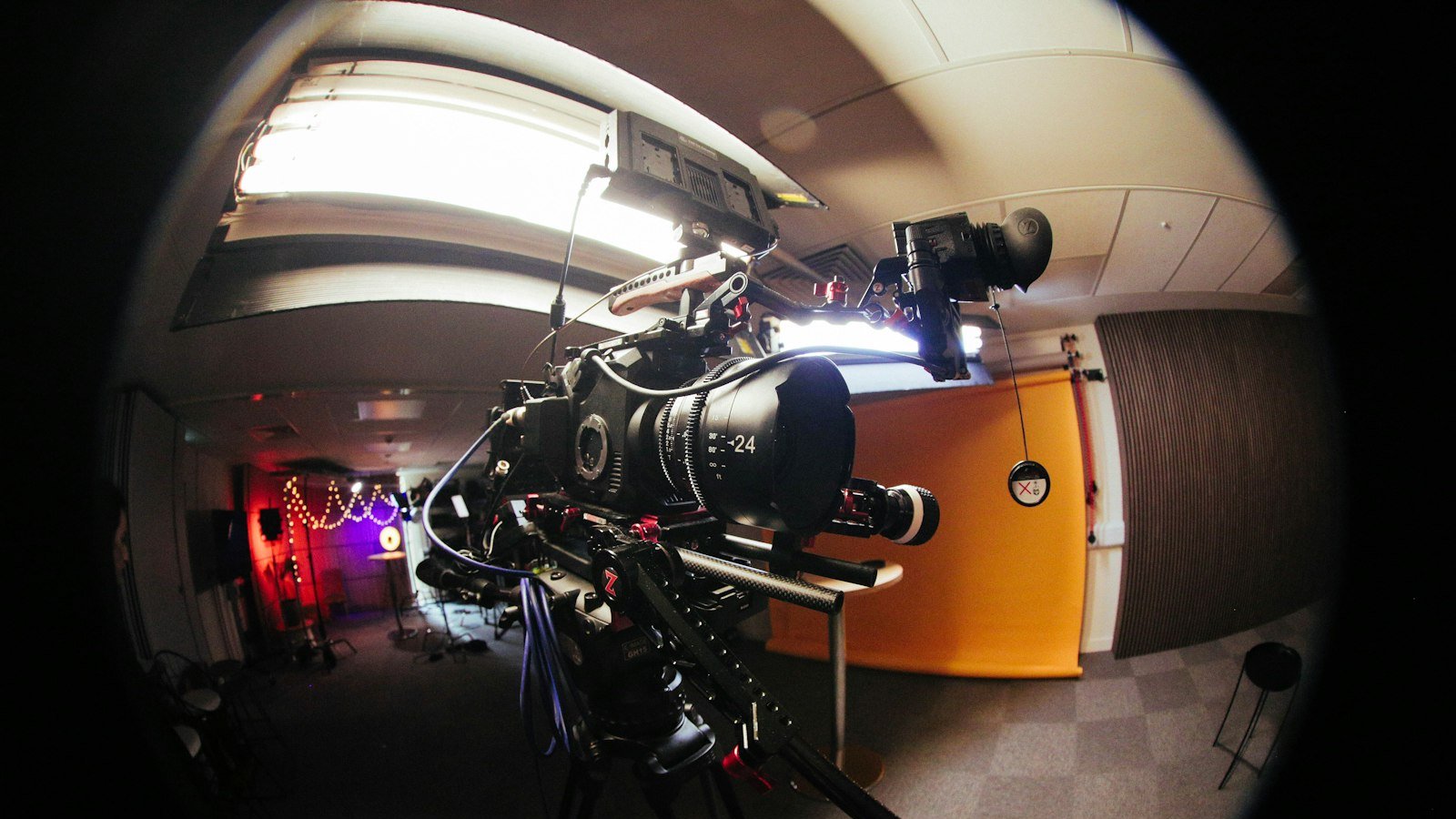 Professional video camera set up on a tripod for a production shoot